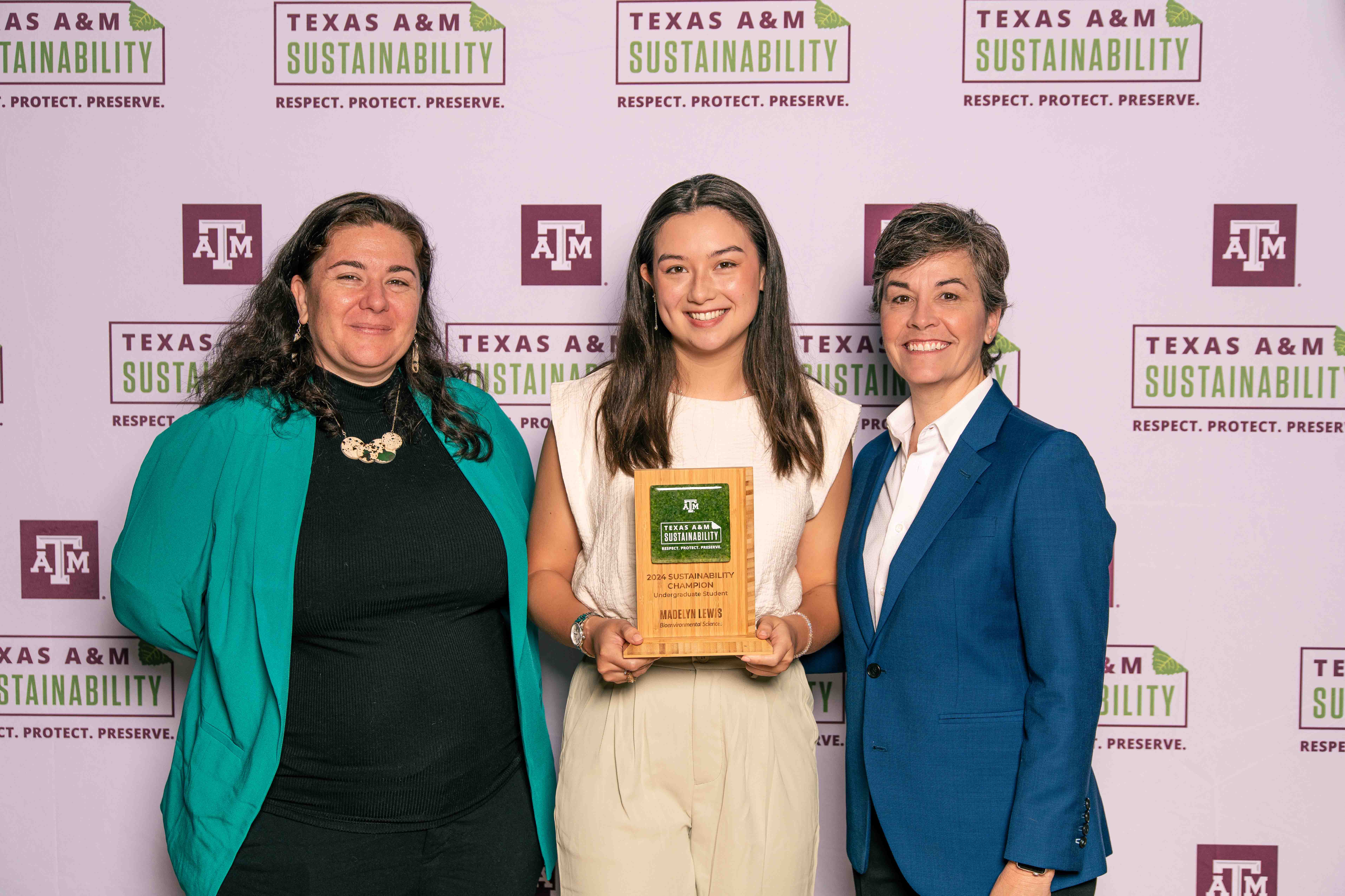 Madelyn Lewis accepting the Sustainability Champion Undergraduate Award with Kelly Wellman and Ben Kalscheur